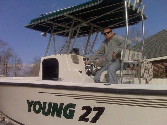 Capt. Dustin Reed pictured with his first custom designed and handmade boat.