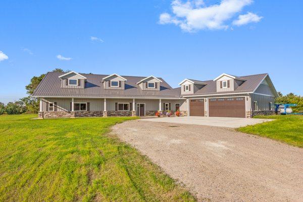 This Post Frame Home built by Structural Buildings features covered porches and open concept living for all of your entertaining needs!