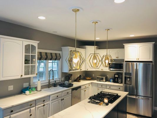 kitchen updates. Cabinets were refinished in white,Calacatta Laza quartz countertops. very happy costumer with the results.