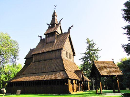 A summer photograph of the Moorhead Stave Church.