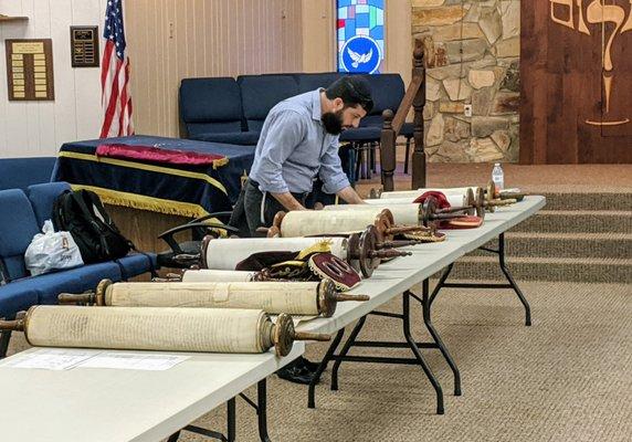 Visiting sofer inspects TBS Torah scrolls