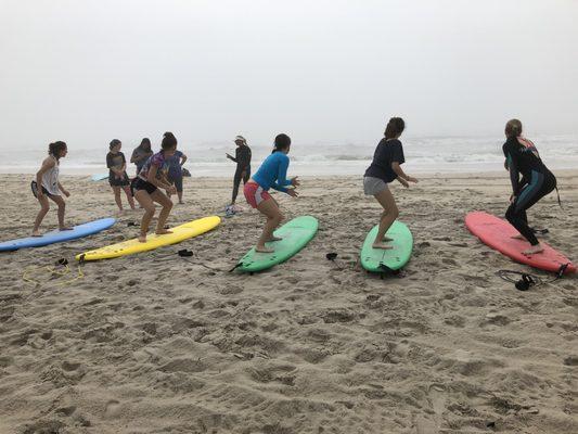 practicing "pop ups" on the sand before going out