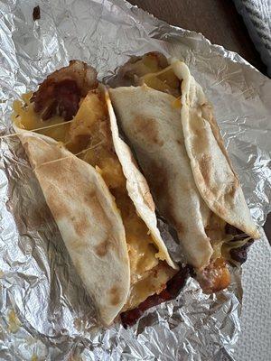 Breakfast tacos with beans, bacon, potato and cheese