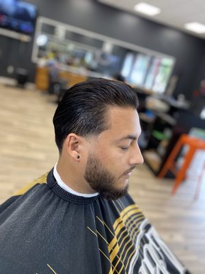 Slicked back haircut with tapered edges