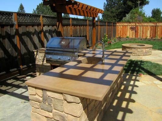 10' by 3 1/2' concrete  bar-top  with integral sink with matching fire ring