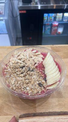 acai bowl w dragon fruit  with honey, granola, almonds and banana.