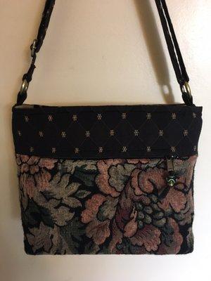 Combo Plus design constructed of upholstery type textile. Measures approximately 15" x 13h zipper closure adjustable strap