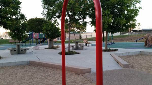 Couple of tables, trees and sand areas