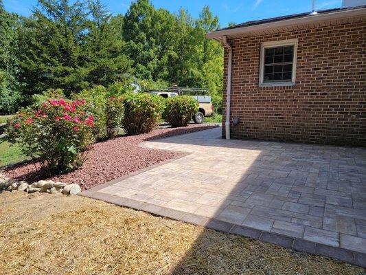 Paver patio with rock design landscape