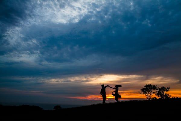 Dancing beneath the painted sky.