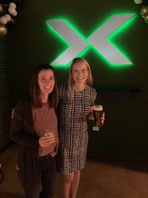 Enjoying a pint by the "X" wall