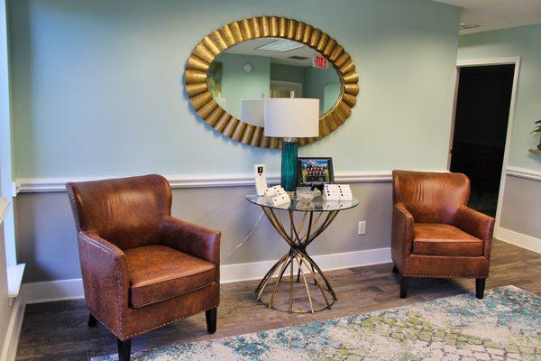 A bright, calm, friendly lobby in tranquil pale blues and greens. Comfortable homey brown leather chairs for clients and guests.