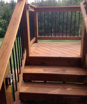 Low voltage lights were added to  the stairway, landing and entertaining area of a deck.