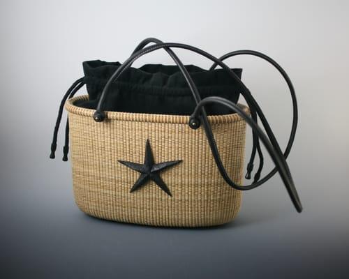 Medium Tote Nantucket Basket by William Kane.  Tote has black straps and liner.  An ebony starfish adorns the side.