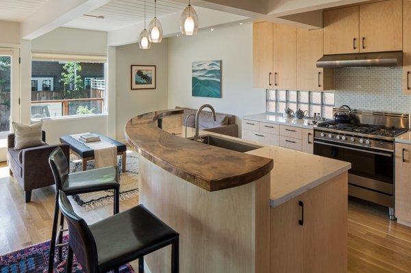 New kitchen with walnut slab raised counter.  Part of a whole house remodel in Half Moon Bay, California.