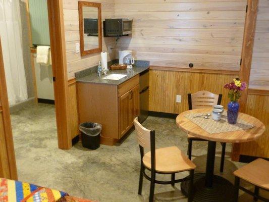 Small cafe table and second sink outside the bath