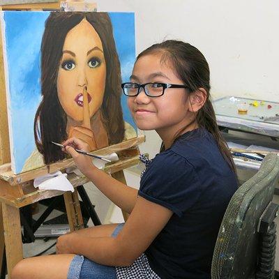 7th grader Jeslyn painting a beautiful portrait.