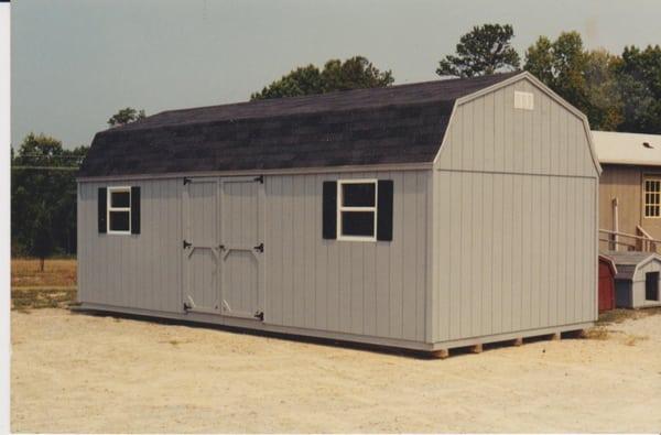 Dove gray shed with black shingles. Black wooden shutters are optional.