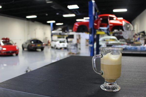 Enjoy fresh Italian espresso right next to a super cool vintage car shop!