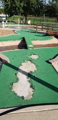 Turf is torn to shreds making some holes UNPLAYABLE