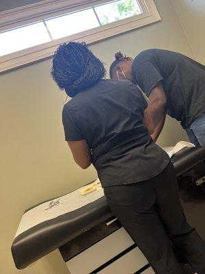 Nurse administering 2 month infant shots.