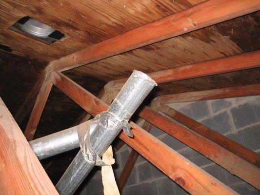 Exhaust vent detached and discharging into the attic.