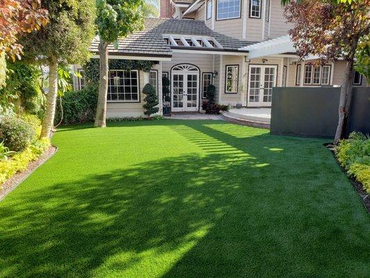 Artificial turf installation in backyard