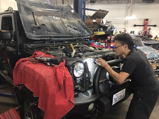 Tyrone doing some modifications to fit the piping for the intercooler on the RIPP supercharger Jeep