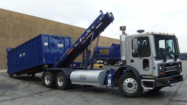 Roll-off Truck dropping off a box