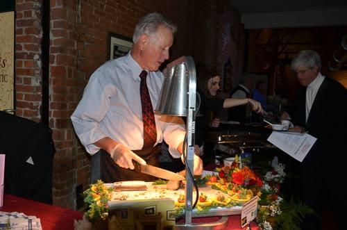 MIke Salmon, Salmon Health & Retirement in Northbridge slices rack of lamb at Heritage Starlight