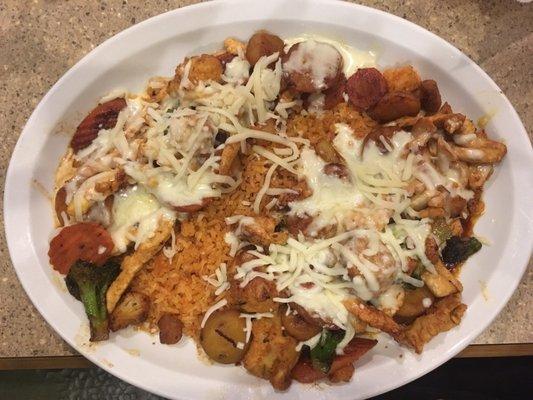 Chicken, vegetables, and rice topped with cheese.