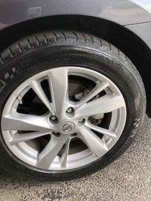 Uneven application of tire dressing and dirty spots on rim.