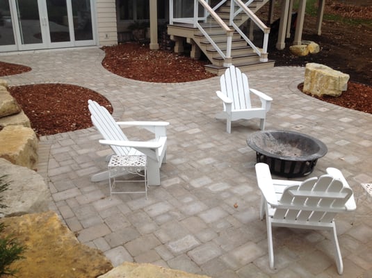 A patio we designed and installed in 2014 using limestone boulders, Interlock LaMont pavers, and cedar mulch