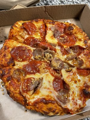 Small pepperoni, sausage and garlic pizza