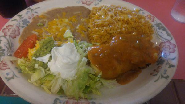 Seafood Chimichanga, salad, rice & bean with sour cream & guacamole.