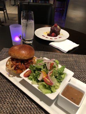 Indy Burger with side salad and balsamic vinaigrette in the front, lemonade and banana sticky toffee pudding in the back