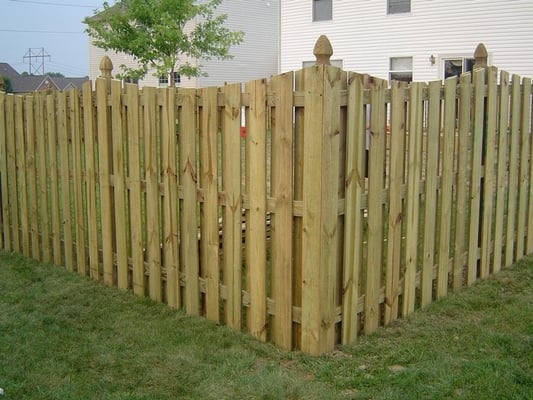 Shadowbox privacy fence with French Gothic posts and Cape Cod top cut by B & B Fencing