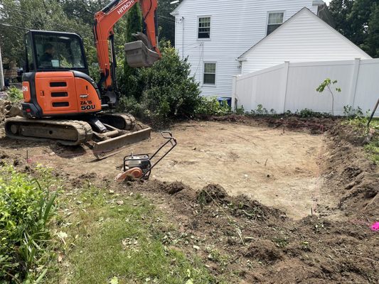 Leveling the area where the patio will go.