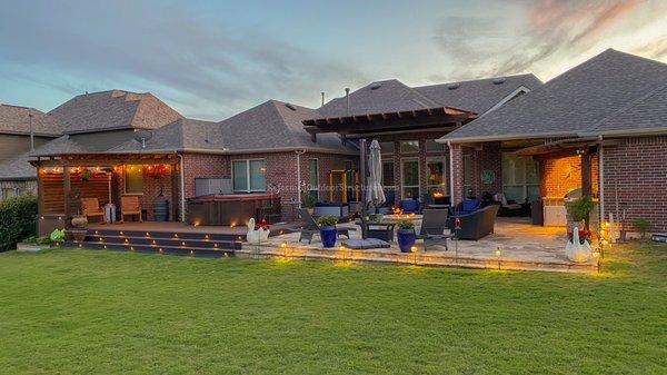 Trex Composite Deck, Flagstone Patio, Fire Pit, Covered Pergola, Outdoor Kitchen, Spa, and Custom Lighting