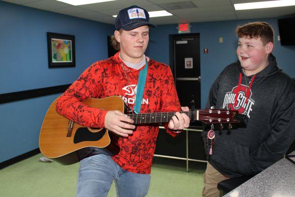 Students having fun and playing guitar.