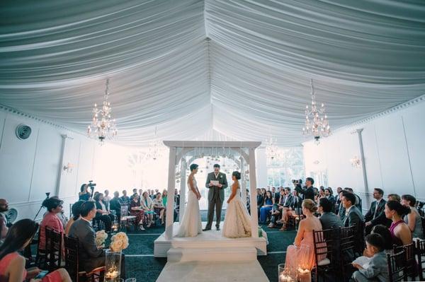 Ceremony in white tent with seating in the round