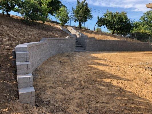 Sideview of the wall showing the curve of the wall with the hillside. Graded and sloped perfectly into a more usable space.