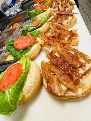 Chicken Ranch Club Deluxe - Blazin buffalo chicken, bacon, swiss cheese, lettuce, tomato, shredded carrots and ranch on toasted Kaiser roll