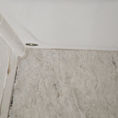 Poorly cut edge of tile along bathtub