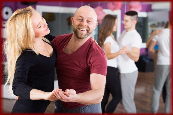 Happy Couples having fun in a dance class