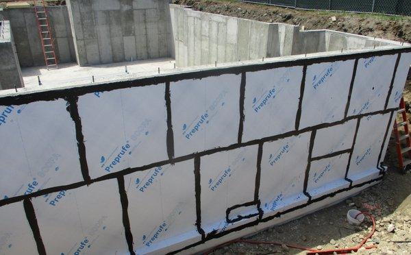 Sheet membrane waterproofing at below grade basement walls