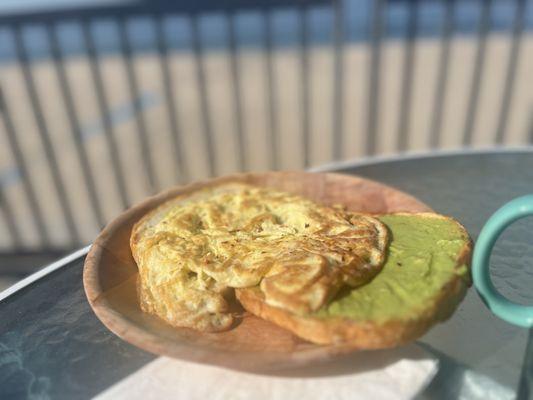 Avocado toast with eggs. The avocado is not smashed avocado, it's some sort of tangy paste. Not good. The egg was fried very hard.