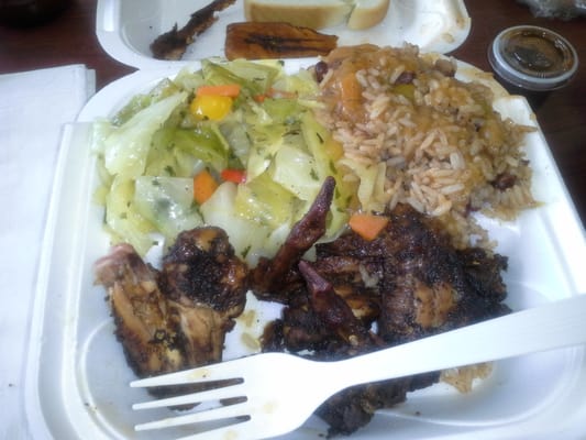 Jerk chicken wings, cabbage, rice and beans.