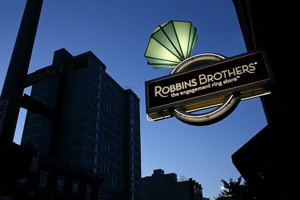 Illuminated Double Faced Projecting Sign created by National Sign Corporation for Robbins Brothers, Seattle