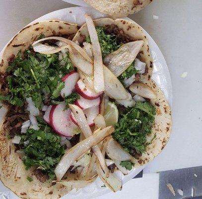 Homemade tortillas, freshly grilled carne, topped w/ cilantro, onion, lime, & their homemade salsa! A side of grilled onions and jalapeño